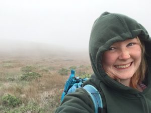 Woman taking selfie in foggy landscape